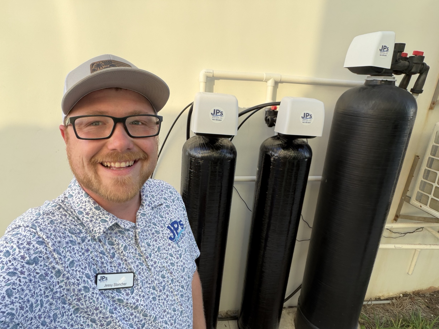 Jessy of JP’s Water Co beside a completed whole-home installation in Panama City Beach